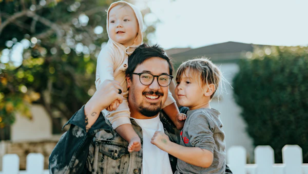 Young family with child in a bright modern living room discussing health insurance options