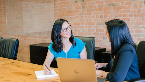 Person reviewing paperwork with a friendly insurance advisor at a desk