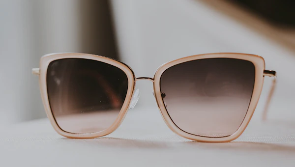 Person trying on modern eyeglasses at an optician shop